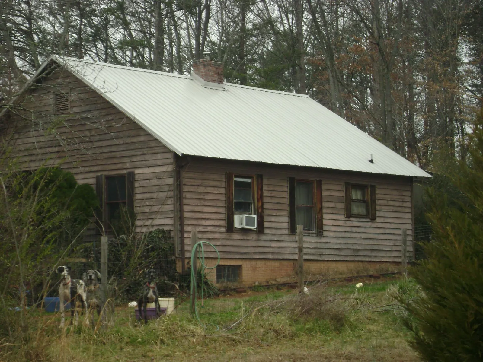 White metal roof on an old wood sided farmhouse, from a Metal Roof Installation job in Newcastle